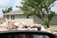 They have already put new siding on while beside them, the debris still needs removed