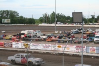Father and son on top of pickup cab discussing race strategy