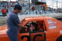 Dad hands him his hat before he can exit the car.